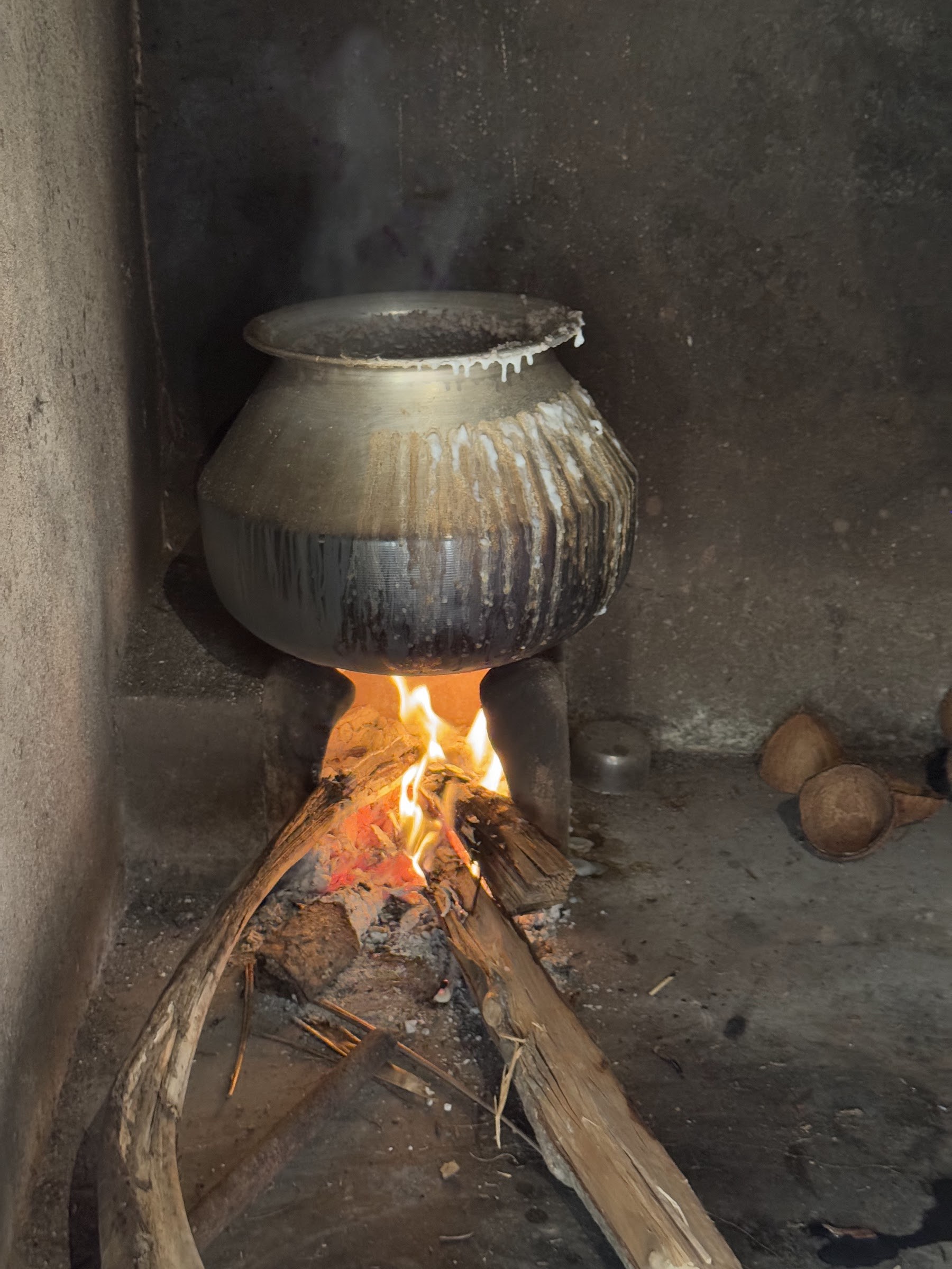 A traditional cooking pot over a wood fire